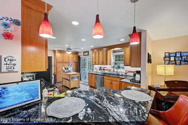 a kitchen with stainless steel appliances granite countertop a refrigerator stove top oven a sink and dishwasher