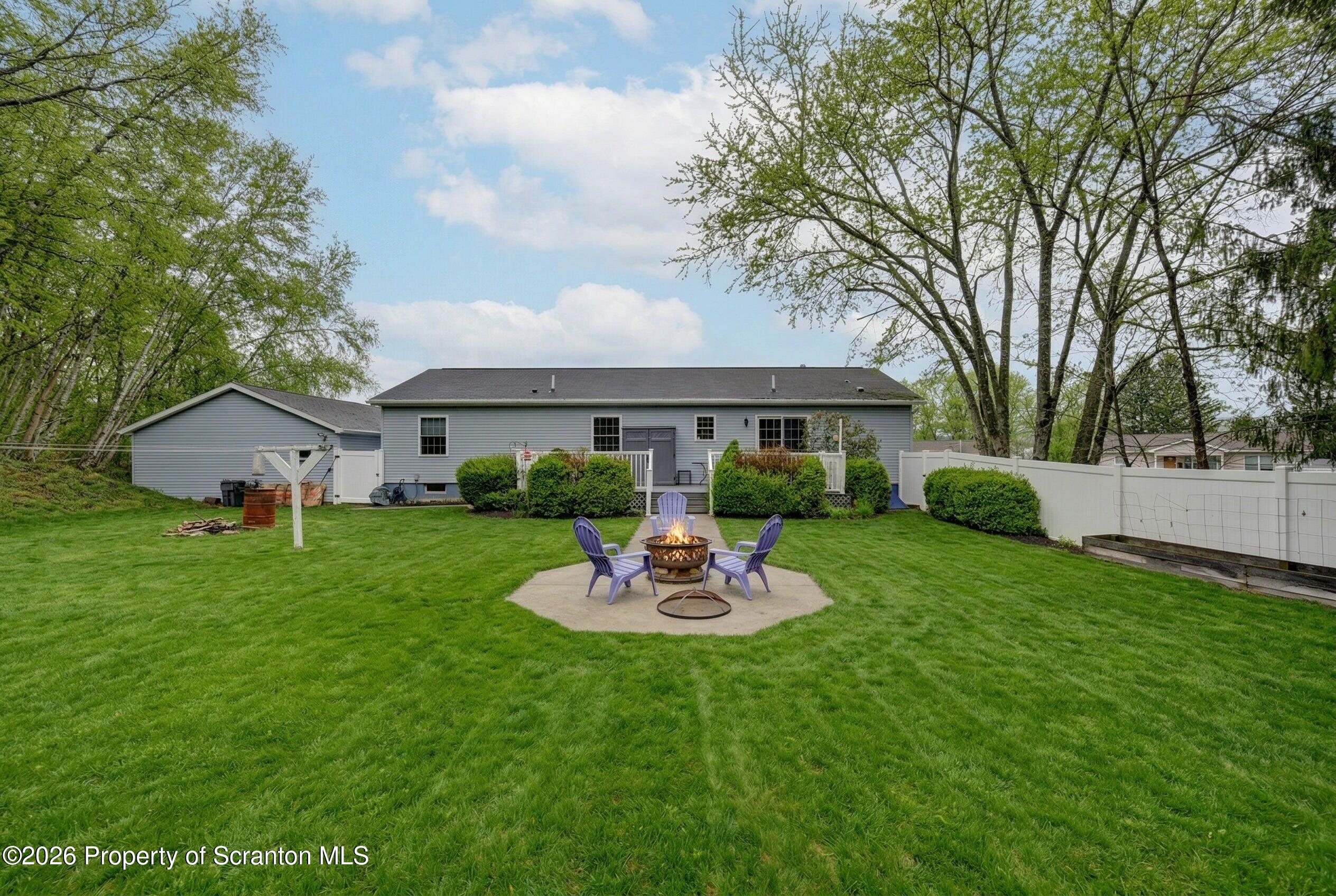 131 Front Street Jessup, PA 18434 - Photo 2 of 58 a front view of a house with a garden and trees