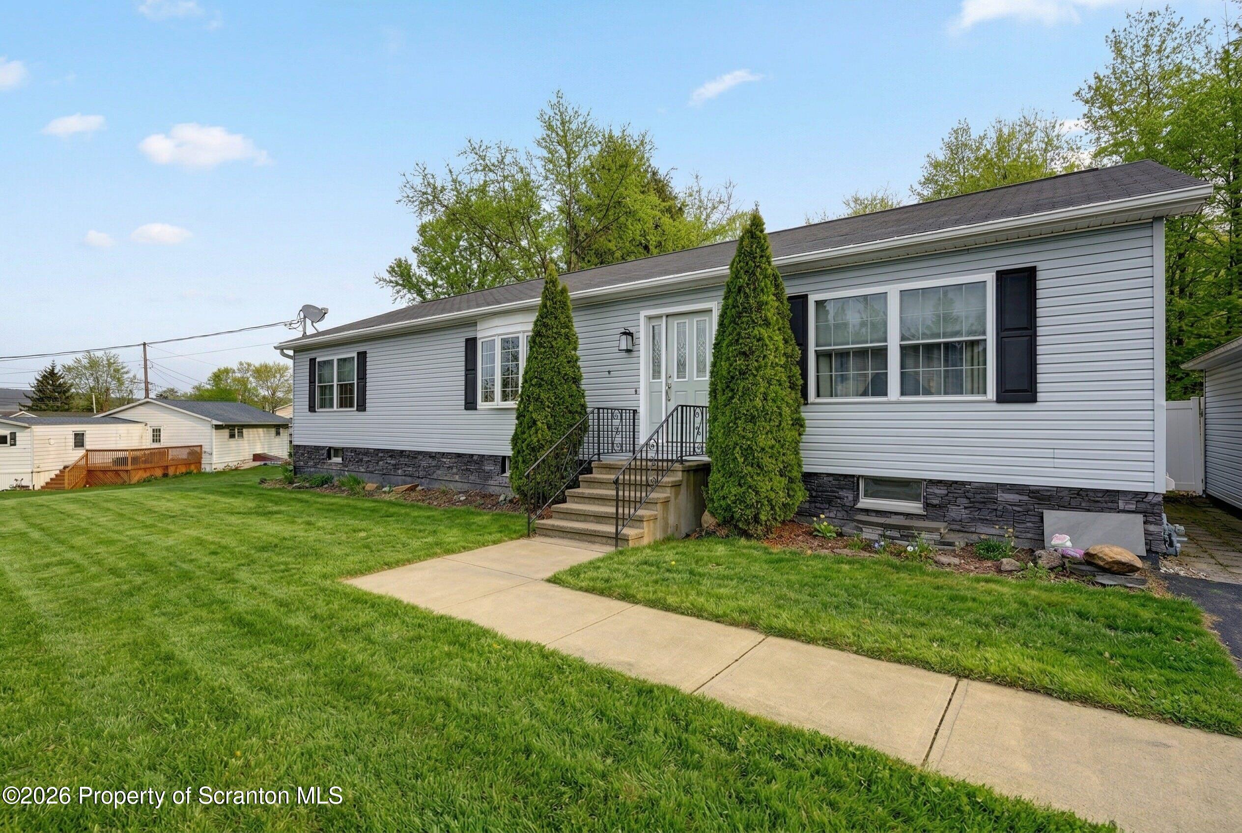 131 Front Street Jessup, PA 18434 - Photo 3 of 58 a front view of house with yard and green space