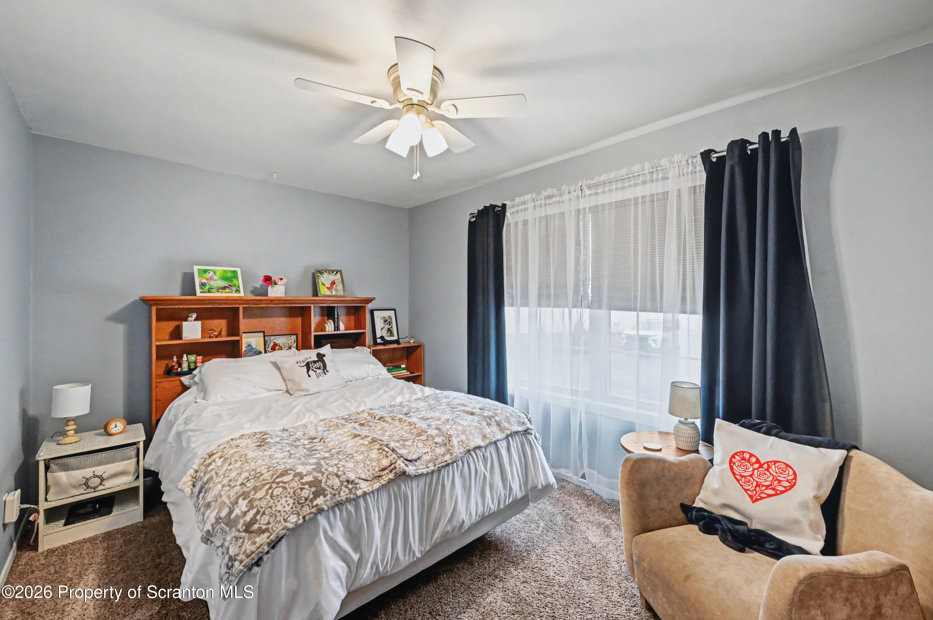 131 Front Street Jessup, PA 18434 - Photo 34 of 58 a bedroom with a bed and a chandelier