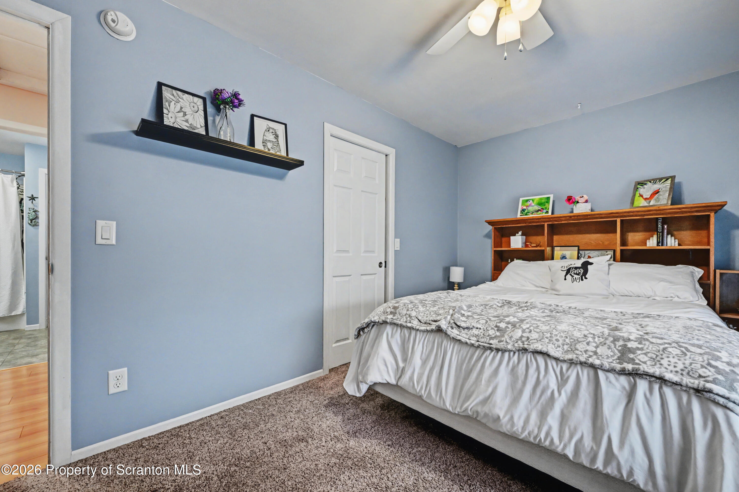 131 Front Street Jessup, PA 18434 - Photo 35 of 58 a bedroom with a bed and a chandelier