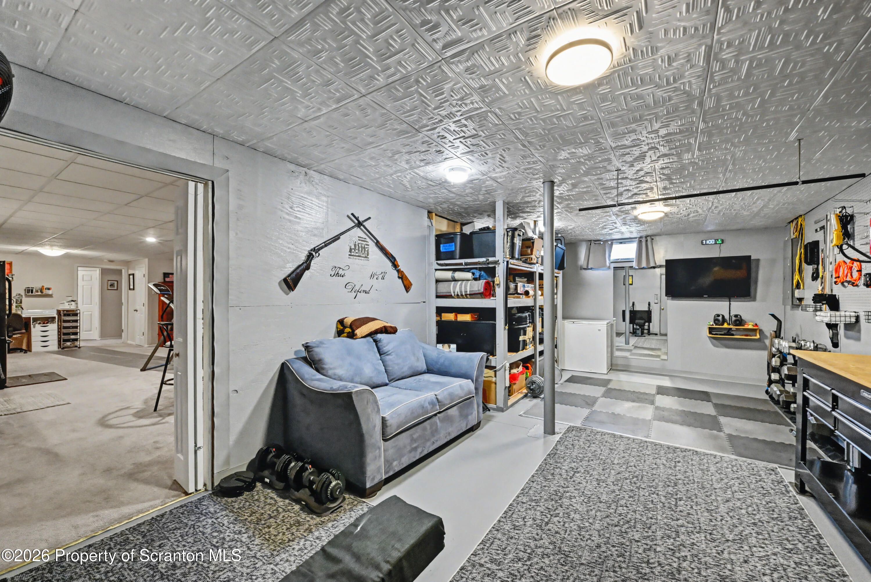 131 Front Street Jessup, PA 18434 - Photo 44 of 58 a living room with lots of furniture and a flat screen tv