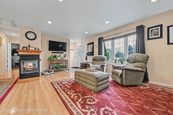 a living room with fireplace furniture and a rug