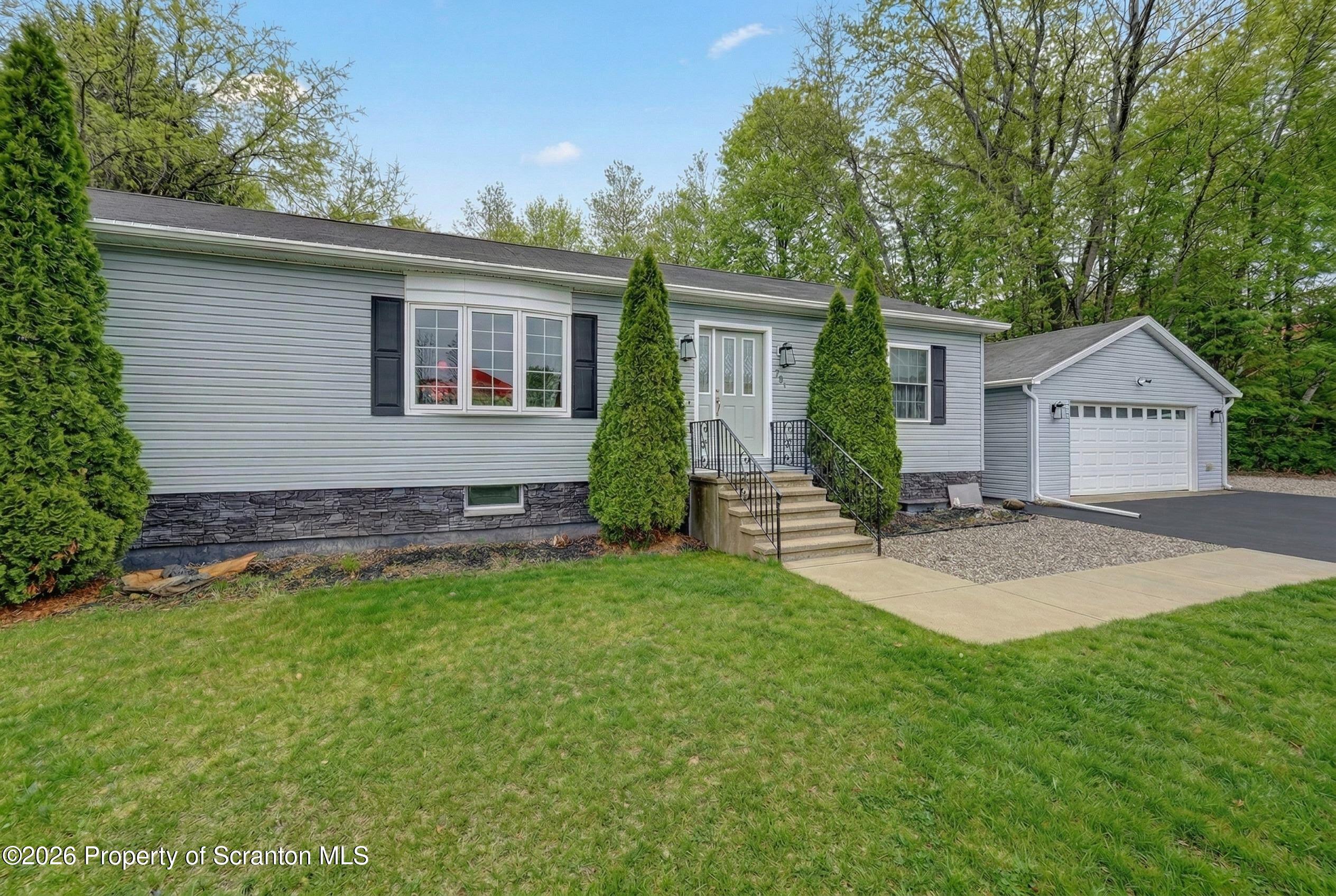 131 Front Street Jessup, PA 18434 - Photo 55 of 58 a view of a house with a yard and plants