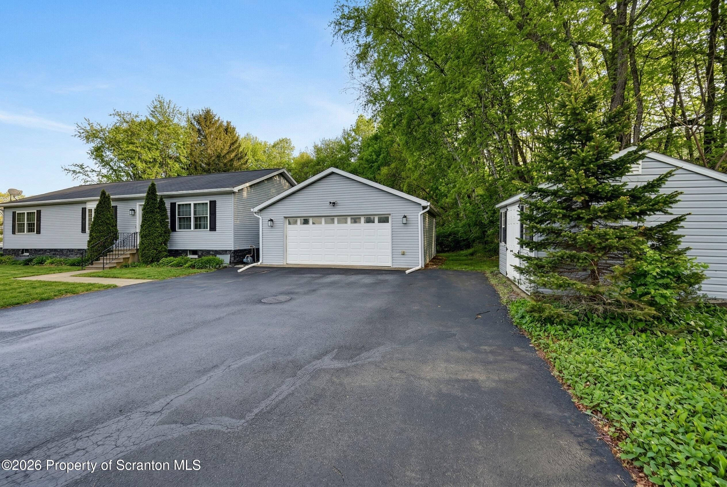 131 Front Street Jessup, PA 18434 - Photo 56 of 58 a view of a house with a small yard and large trees