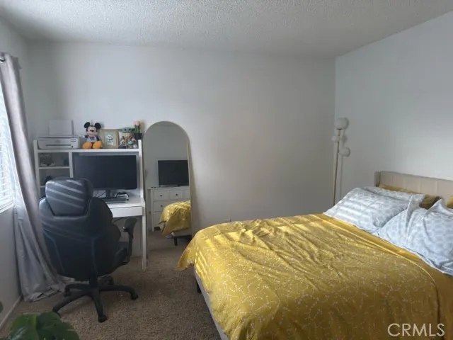 a bedroom with a bed and a chair