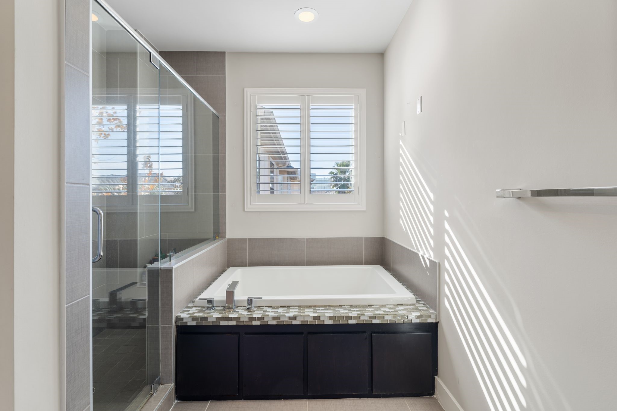 5911 Rose Street Houston, TX 77007 - Photo 18 of 40 Enjoy a long, relaxing bath or unwind in the spacious walk-in shower featuring a built-in shower bench.