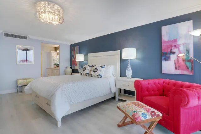 a bedroom with a large bed and a large window