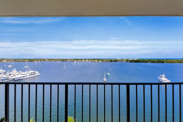 a balcony with chairs and city view
