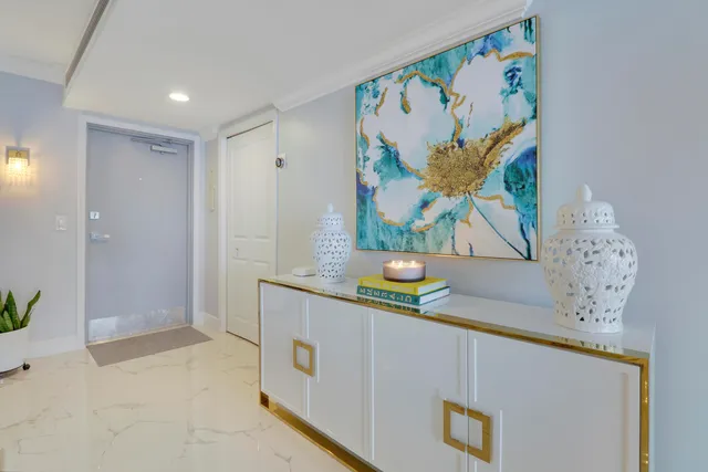 a hallway with painting on it and a table