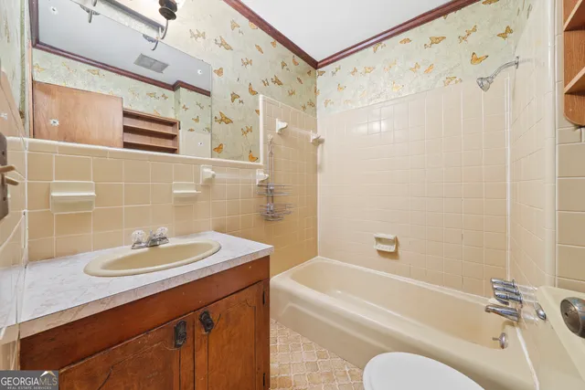 a bathroom with a sink a mirror a bathtub and shower