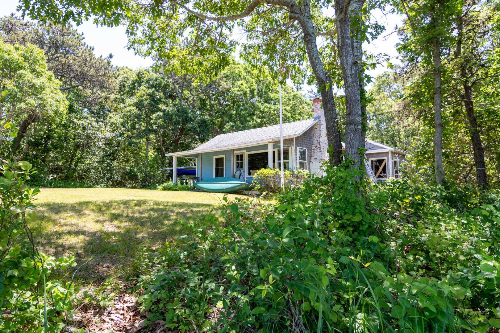 8 Trapps Pond Road Edgartown, MA 02539 - Photo 4 of 6 a front view of a house with a garden