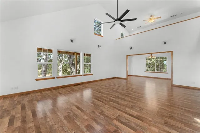 a view of a dining room with furniture and a chandelier