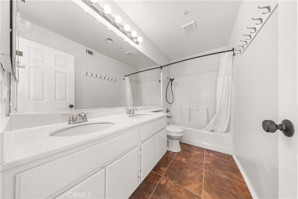 2 Cameron Circle Lake Forest, CA 92610 - Photo 23 of 45 a spacious bathroom with a double vanity sink toilet mirror and shower