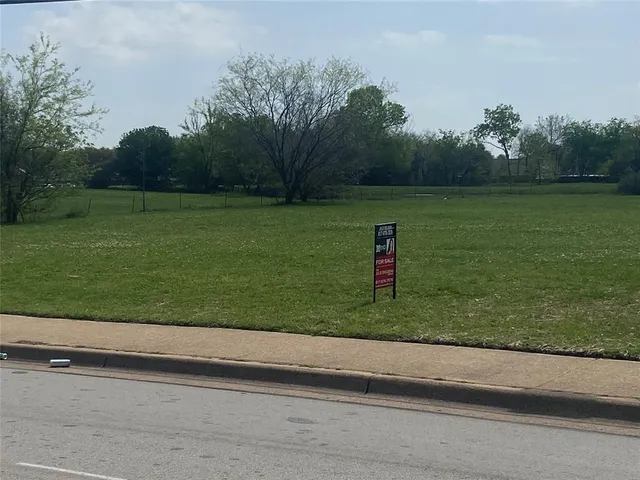 a view of a field with an ocean