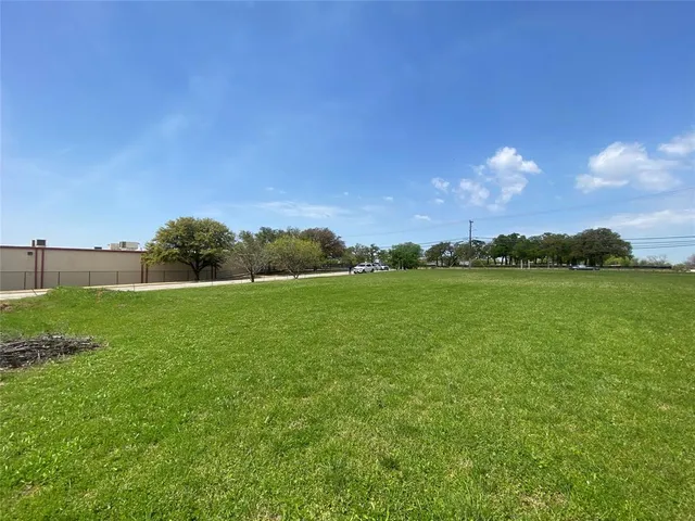 a view of a green field with clear sky