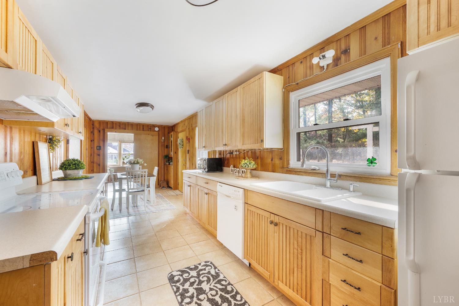 41 Piedmont Road Rustburg, VA 24588 - Photo 21 of 51 a large kitchen with granite countertop a large window and white appliances