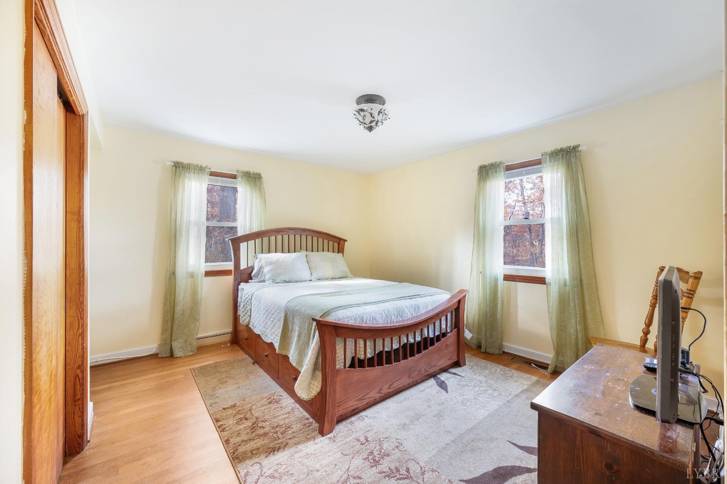 41 Piedmont Road Rustburg, VA 24588 - Photo 29 of 51 a bedroom with a bed and wooden floor