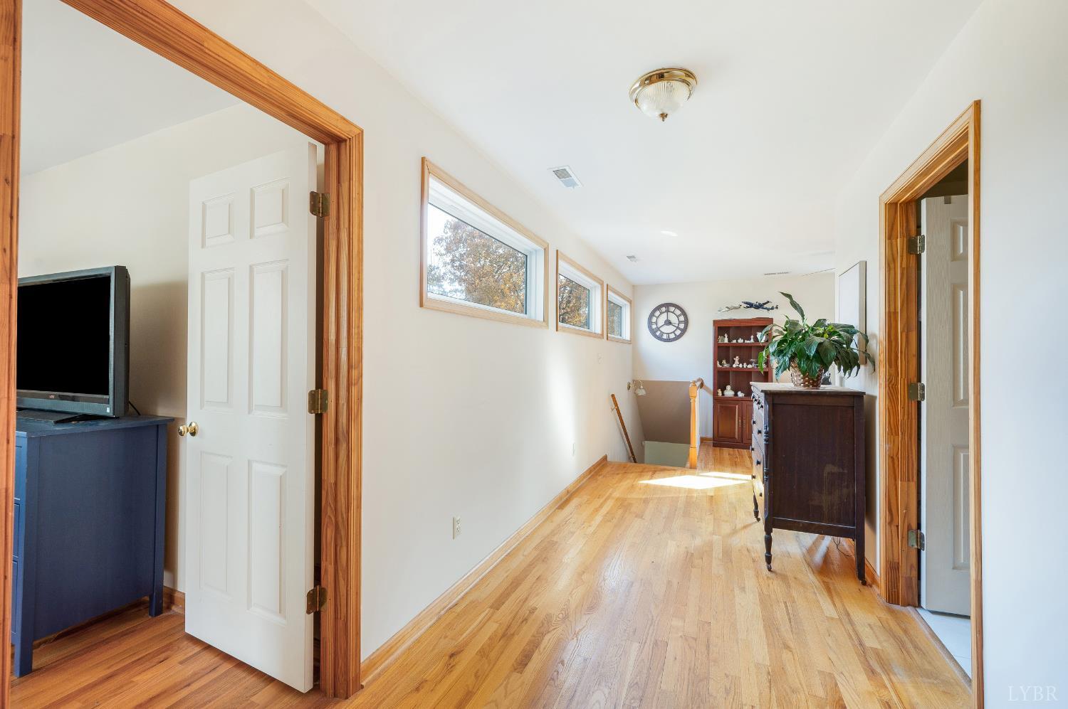 41 Piedmont Road Rustburg, VA 24588 - Photo 41 of 51 a view of a hallway with wooden floor and a living room