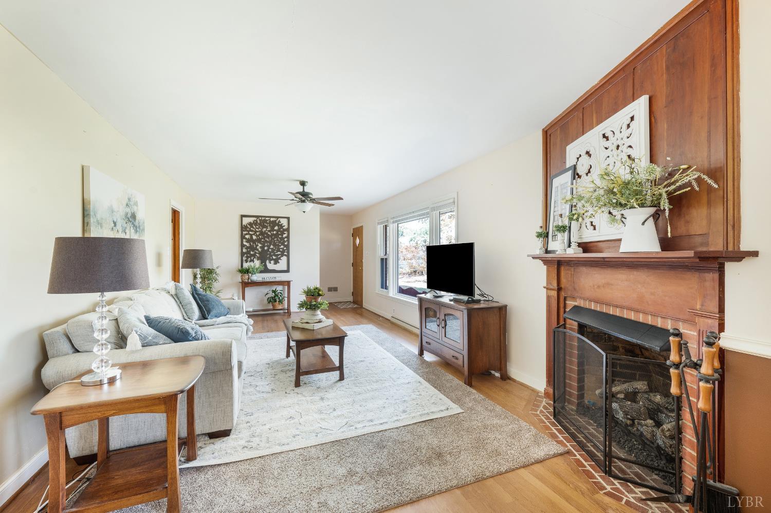 41 Piedmont Road Rustburg, VA 24588 - Photo 10 of 51 a living room with furniture a flat screen tv and a fireplace