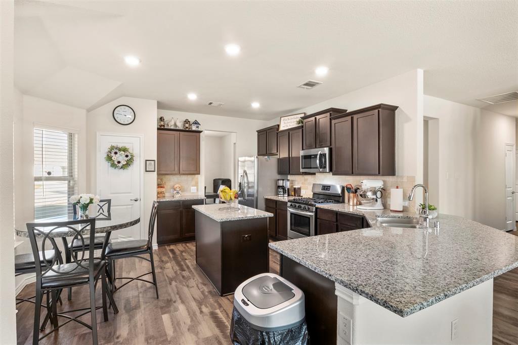 217 Watson Street Red Oak, TX 75154 - Photo 14 of 40 a kitchen with sink a table and chairs
