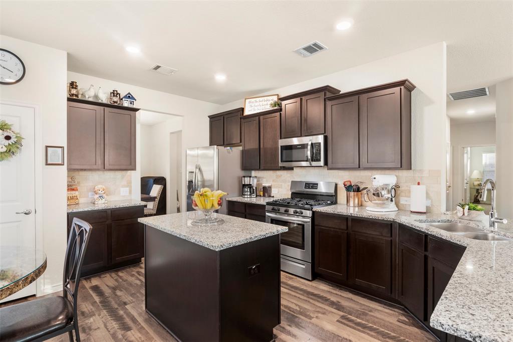 217 Watson Street Red Oak, TX 75154 - Photo 15 of 40 a kitchen with a sink stove top oven and refrigerator