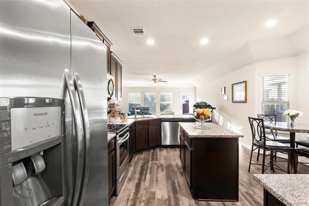 217 Watson Street Red Oak, TX 75154 - Photo 16 of 40 a kitchen with stainless steel appliances granite countertop a refrigerator a sink a stove and island