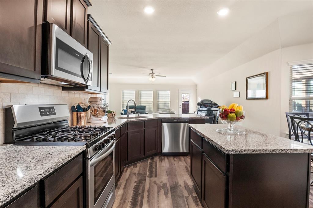 217 Watson Street Red Oak, TX 75154 - Photo 40 of 40 a kitchen with stainless steel appliances granite countertop a sink stove and refrigerator