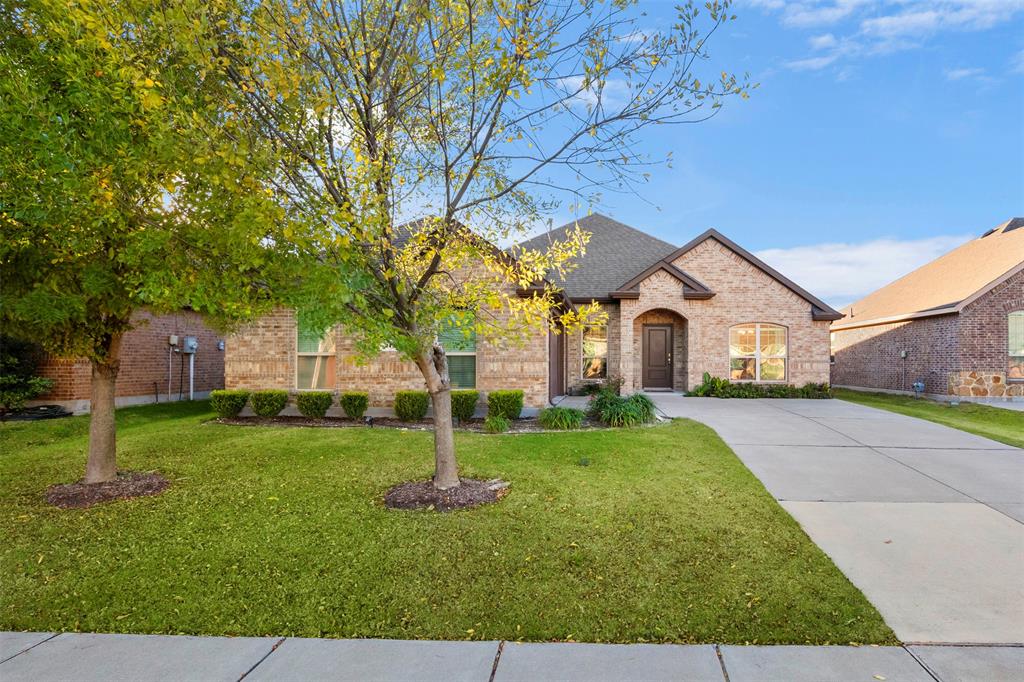 217 Watson Street Red Oak, TX 75154 - Photo 2 of 40 a front view of a house with garden