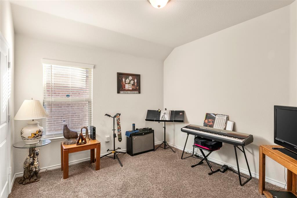 217 Watson Street Red Oak, TX 75154 - Photo 28 of 40 a living room with furniture and a flat screen tv