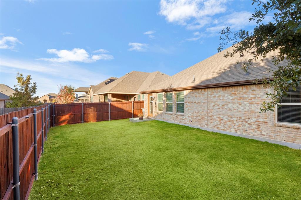 217 Watson Street Red Oak, TX 75154 - Photo 37 of 40 a view of a backyard with a garden