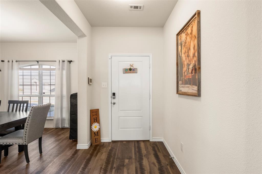 217 Watson Street Red Oak, TX 75154 - Photo 6 of 40 a view of a livingroom with wooden floor and a window