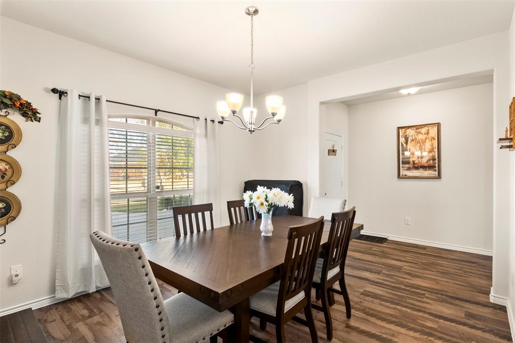 217 Watson Street Red Oak, TX 75154 - Photo 7 of 40 a dining room with furniture a chandelier and wooden floor