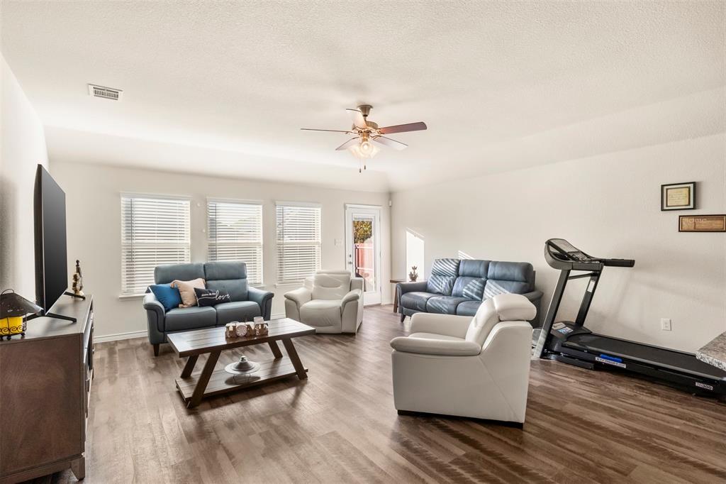 217 Watson Street Red Oak, TX 75154 - Photo 8 of 40 a living room with furniture and a flat screen tv