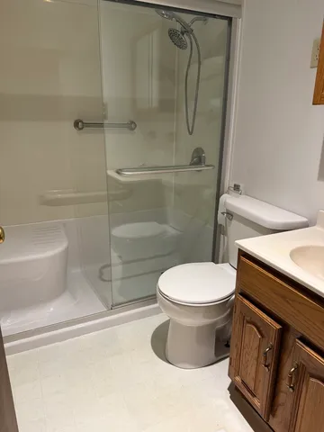 a bathroom with a toilet and a shower