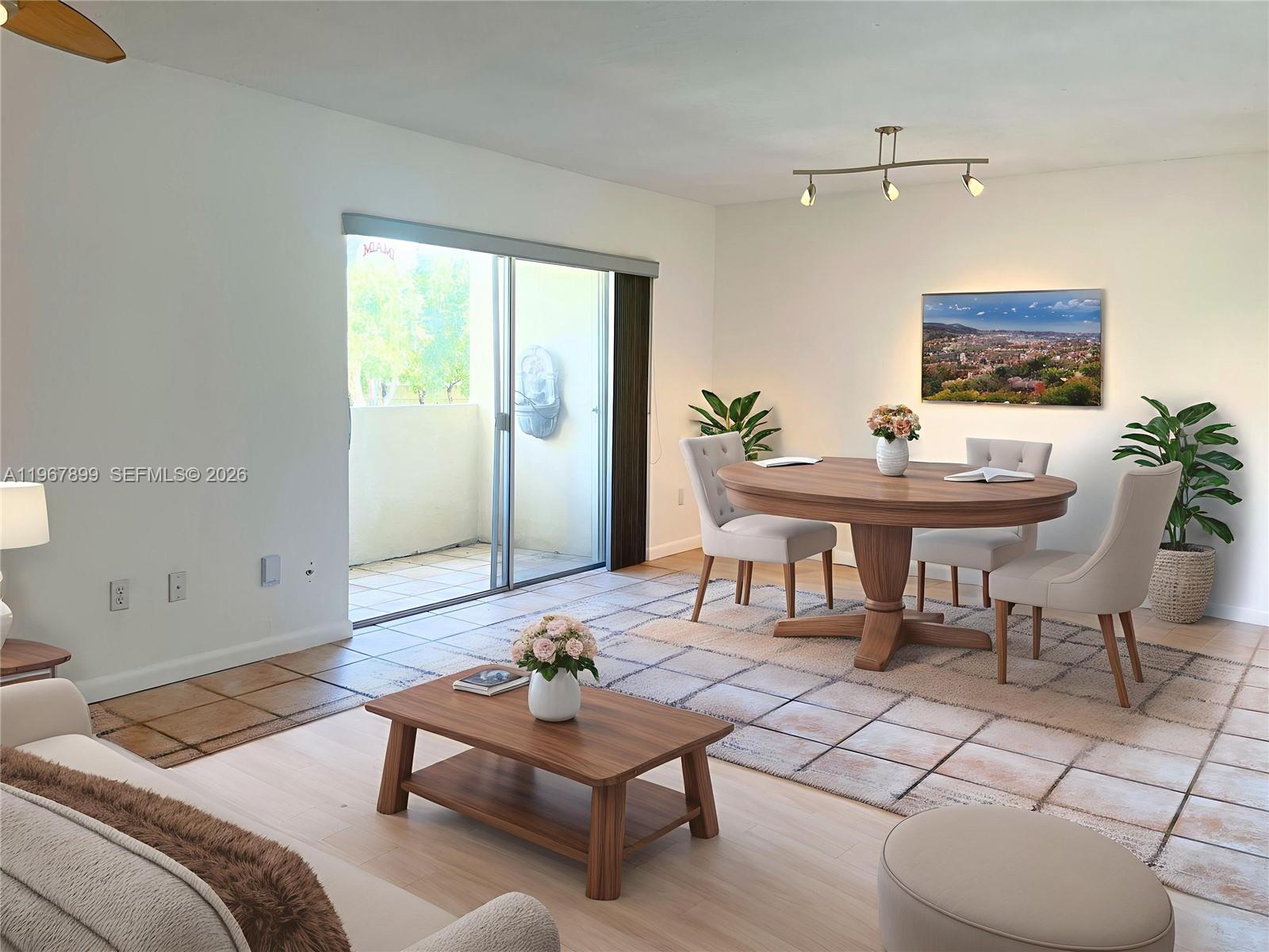 7705 Southwest 86th Street, Unit B213 Miami, FL 33143 - Photo 1 of 14 a living room with furniture a rug and a table