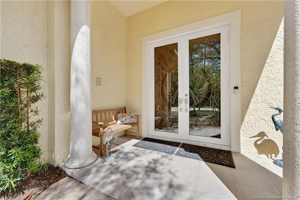 a dining room with furniture a chandelier and window
