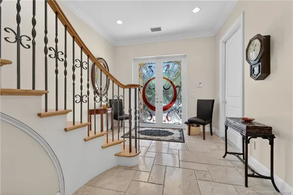a living room with furniture a large window and a flat screen tv