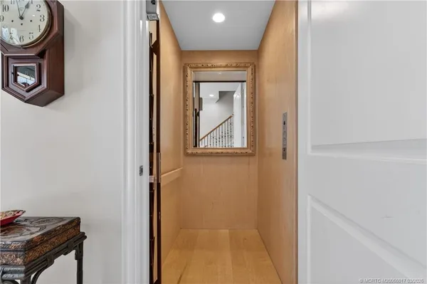 a bathroom with a granite countertop sink vanity mirror and toilet