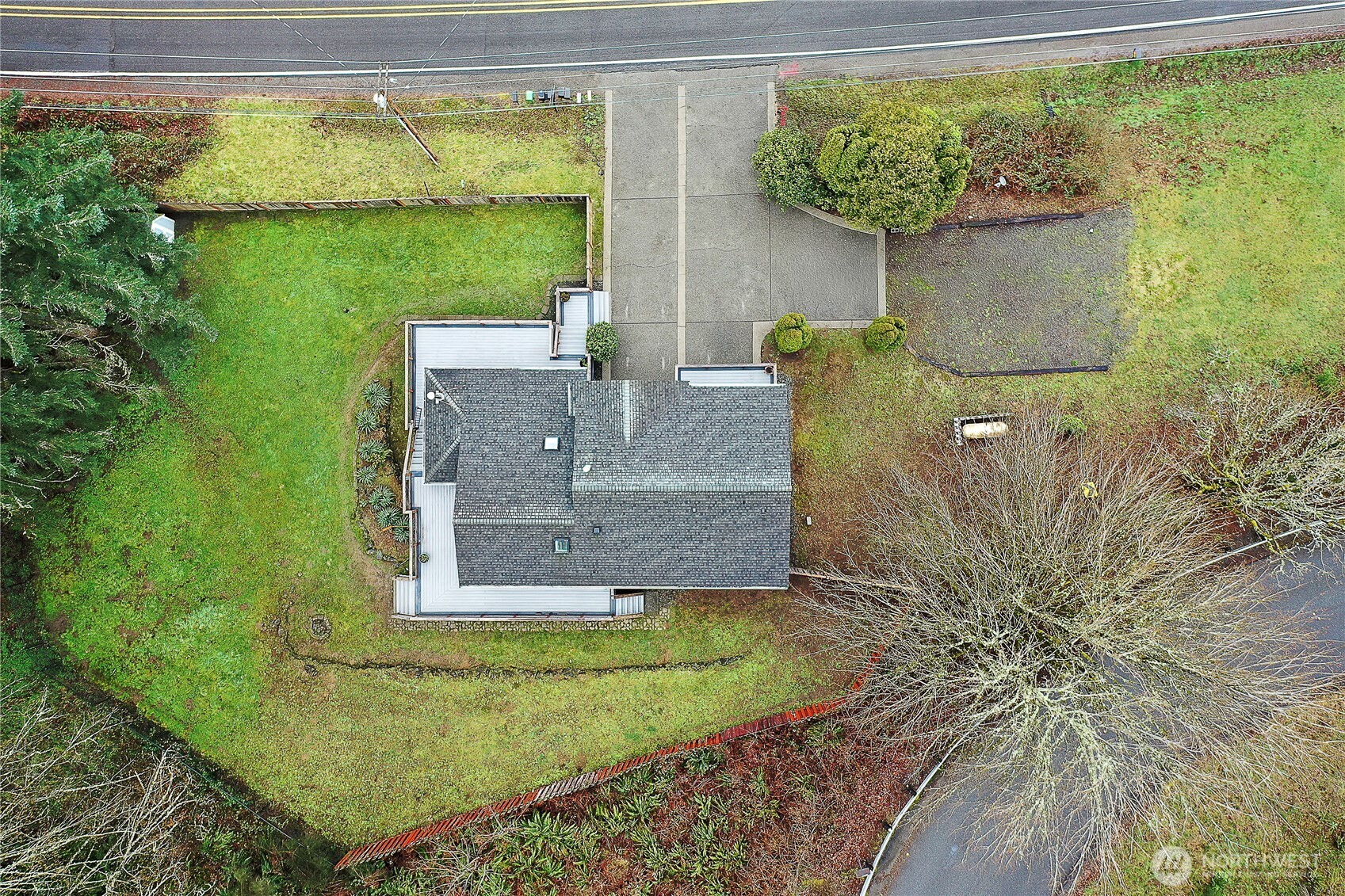 7239 Long Lake Road Southeast Port Orchard, WA 98367 - Photo 20 of 22 a view of a house with a yard potted plants and a fountain