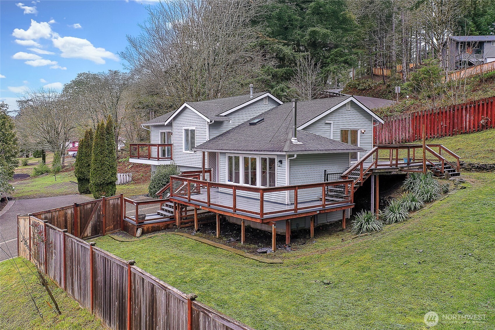7239 Long Lake Road Southeast Port Orchard, WA 98367 - Photo 2 of 22 a view of a house with wooden deck and furniture