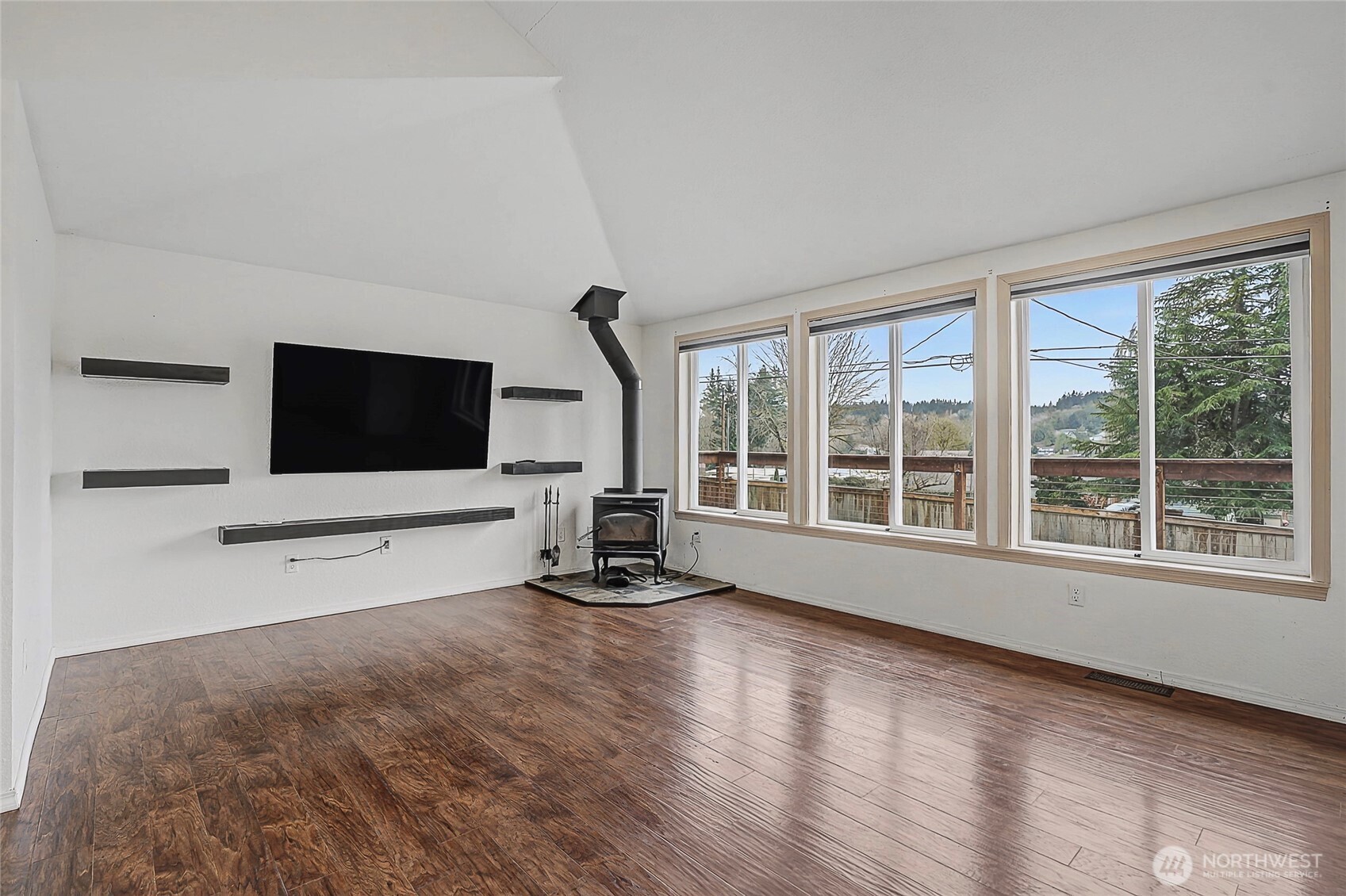 7239 Long Lake Road Southeast Port Orchard, WA 98367 - Photo 3 of 22 a view of a livingroom with wooden floor and a flat screen tv