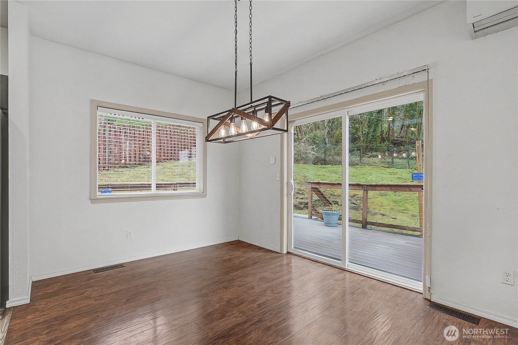 7239 Long Lake Road Southeast Port Orchard, WA 98367 - Photo 5 of 22 a view of an empty room with wooden floor and a window