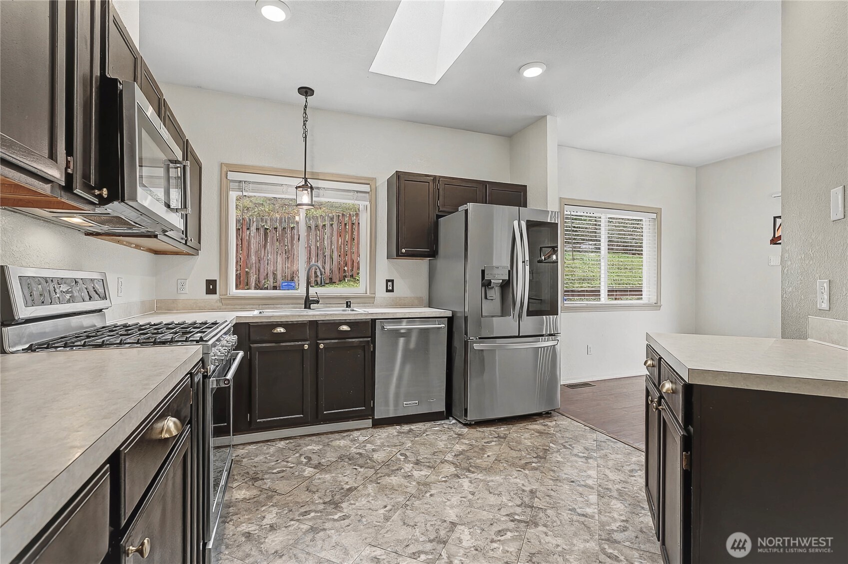 7239 Long Lake Road Southeast Port Orchard, WA 98367 - Photo 7 of 22 a kitchen with stainless steel appliances granite countertop a sink stove and refrigerator