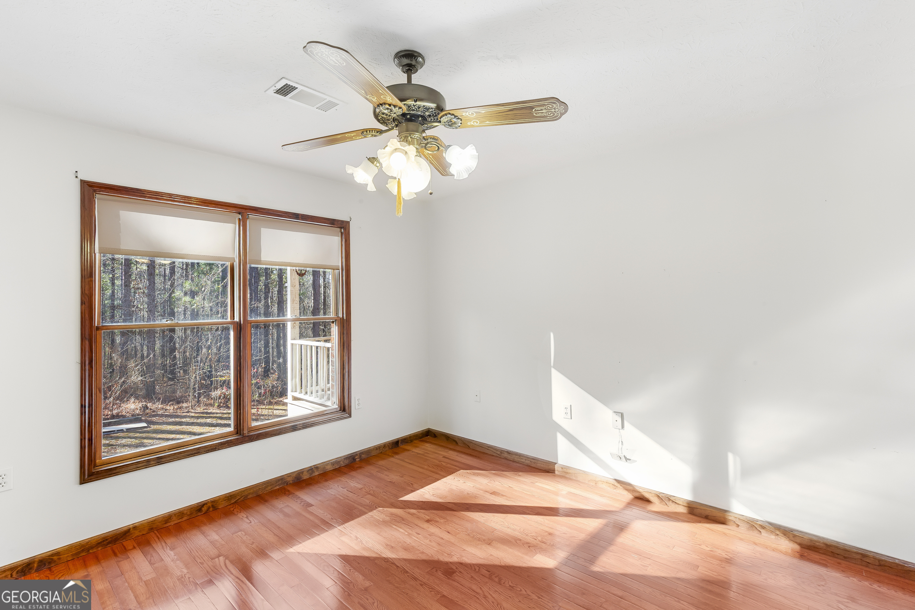 269 High Point Road Buchanan, GA 30113 - Photo 16 of 41 a view of a bedroom with a ceiling fan and a window