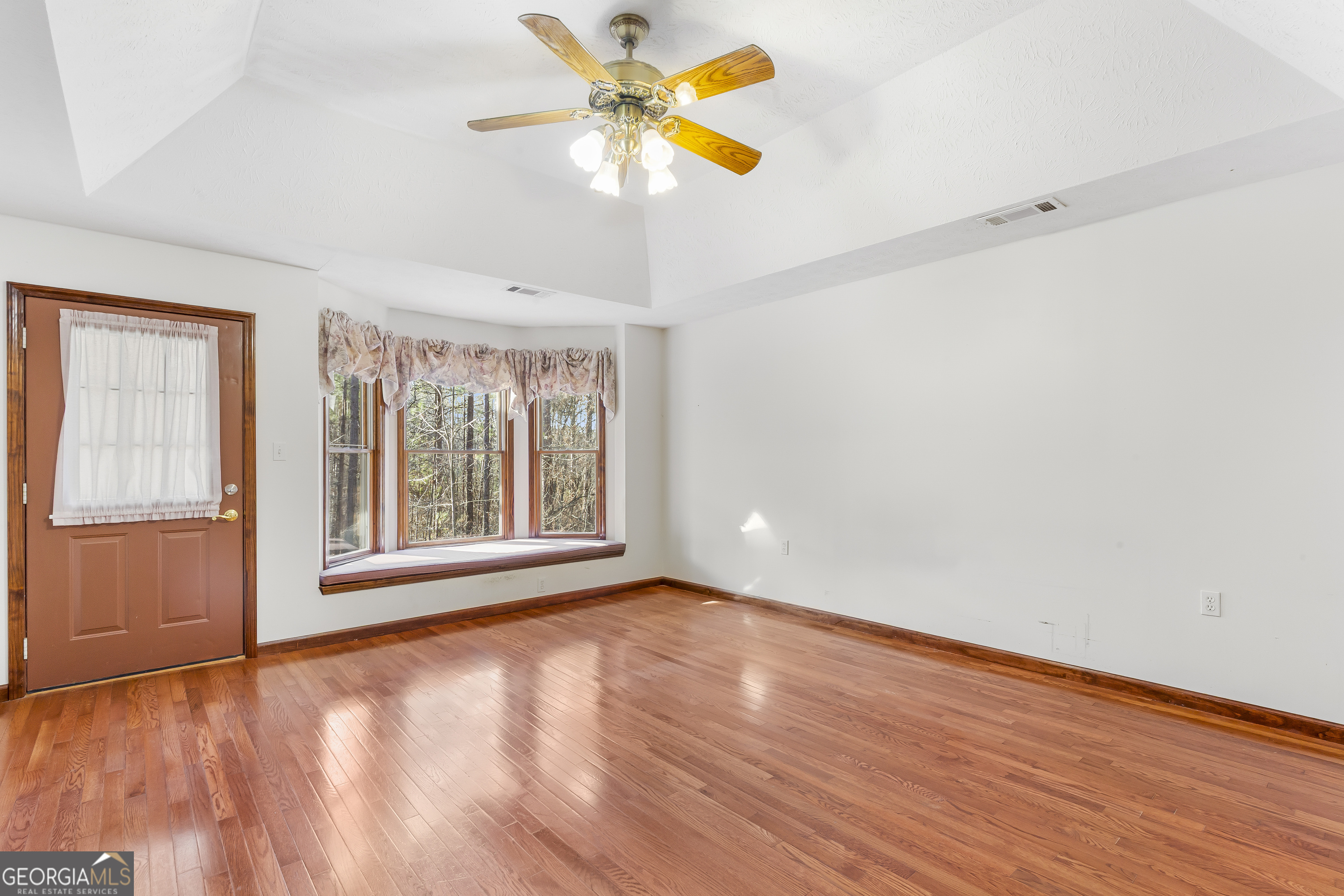 269 High Point Road Buchanan, GA 30113 - Photo 22 of 41 a view of an empty room with window and wooden floor