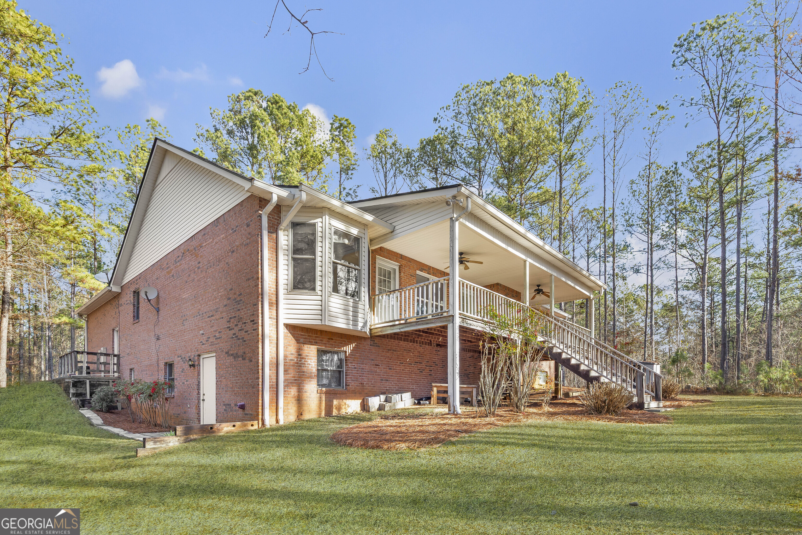 269 High Point Road Buchanan, GA 30113 - Photo 31 of 41 a view of a white house with a big yard and potted plants