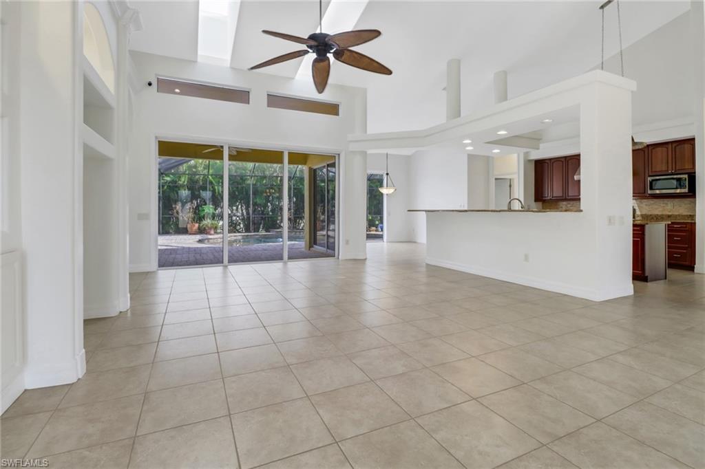 15480 River By Road Fort Myers, FL 33908 - Photo 11 of 48 Unfurnished living room with a high ceiling, ceiling fan, and light tile patterned floors