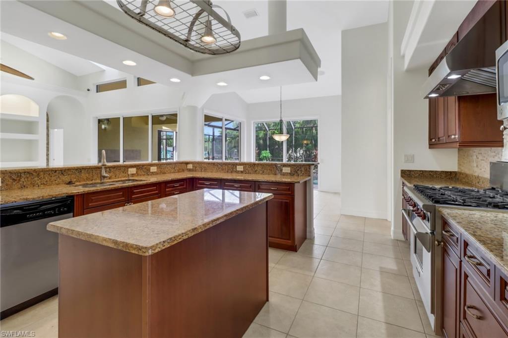 15480 River By Road Fort Myers, FL 33908 - Photo 16 of 48 Kitchen with wall chimney exhaust hood, dishwasher, high end range, decorative light fixtures, and a center island