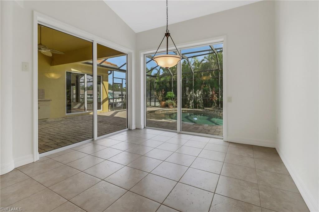 15480 River By Road Fort Myers, FL 33908 - Photo 18 of 48 Unfurnished dining area featuring ceiling fan, vaulted ceiling, and light tile patterned floors